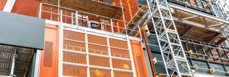 Skyscraper in New York under construction with an elevator lift. Detail, low angle view.